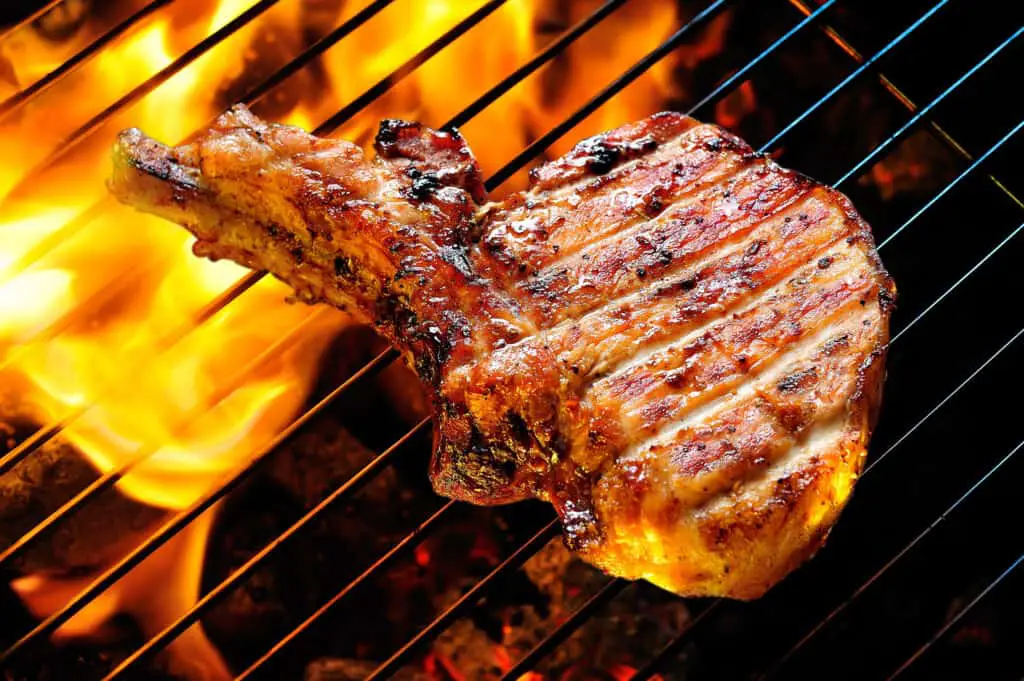 Grilled pork steak on the grill.