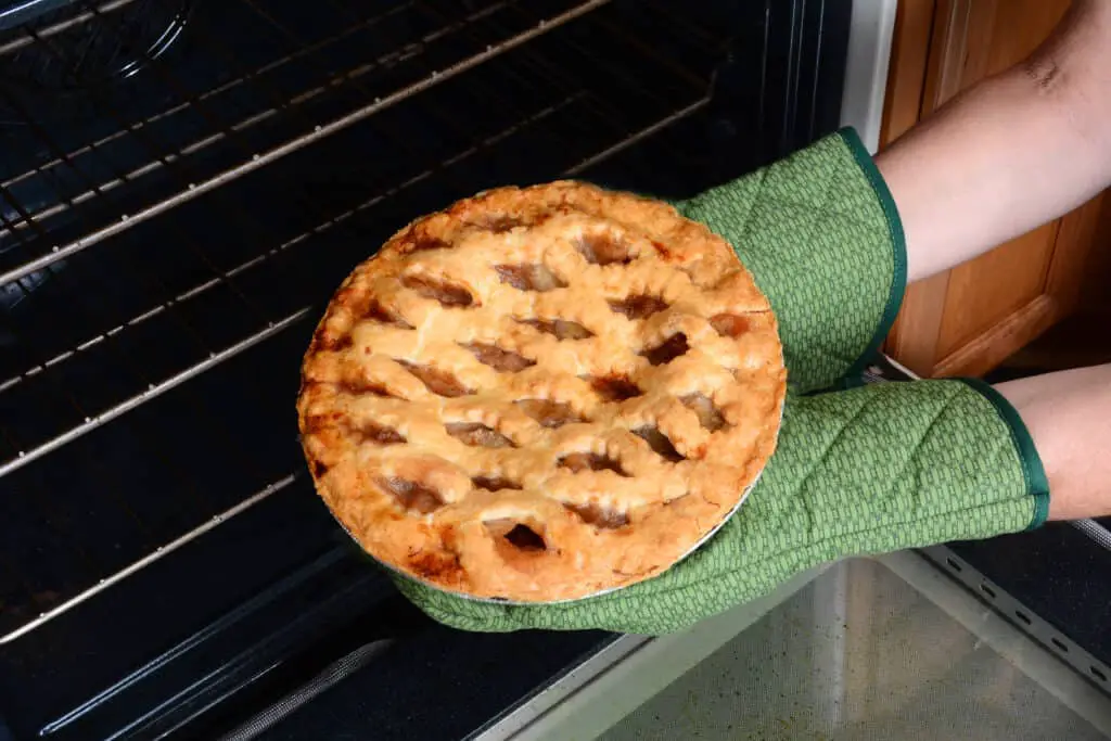 Taking Apple Pie From Oven