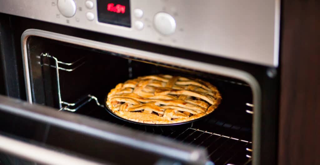 Baking traditional apple pie in the oven.