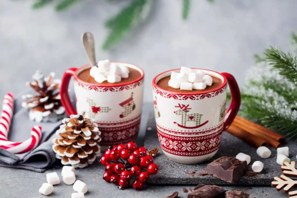 Hot chocolate drink with marshmallows in Christmas mugs. Christmas, New Year's decoration. 