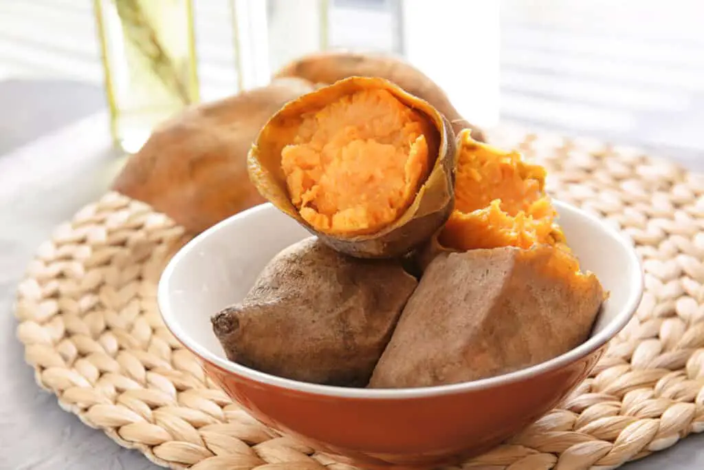 Dish with baked sweet potato on a wicker mat.