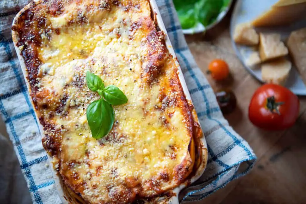 Lasagna with crusts and mushrooms served on plate