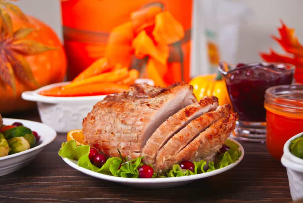 Traditional sliced honey glazed ham for festive Christmas or Thanksgiving table.