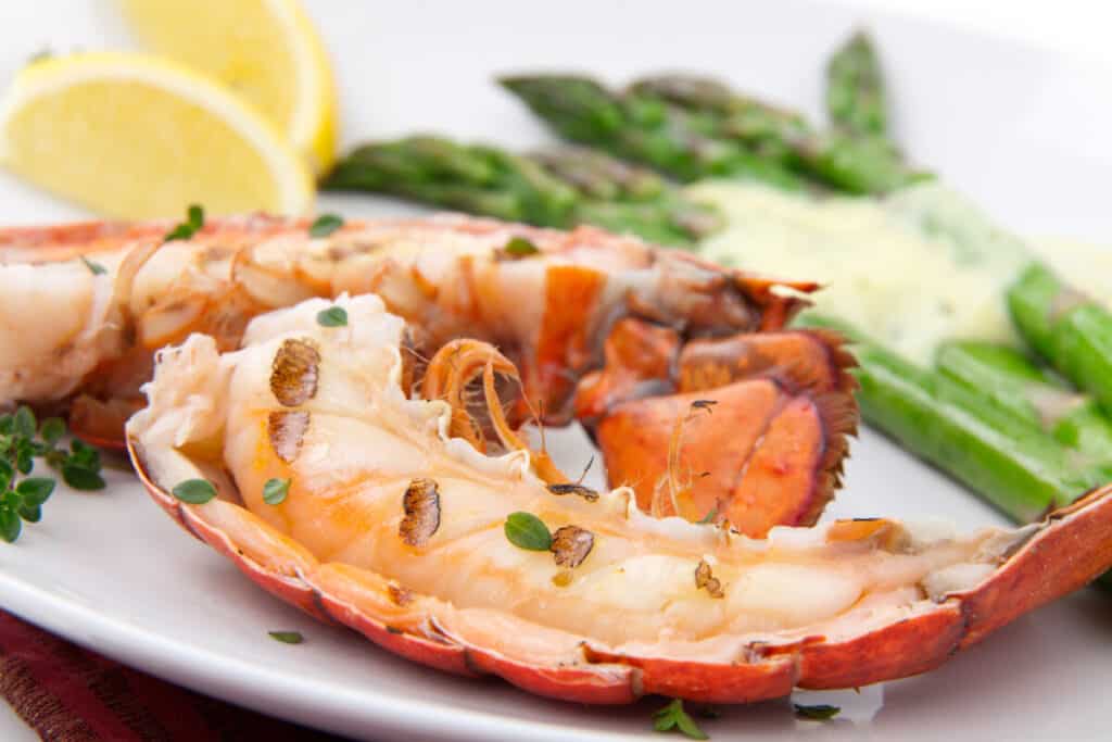 Grilled lobster tails served with asparagus and Bearnaise sauce