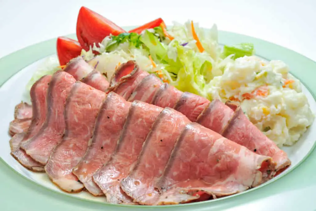 Roast beef lunch meat with a side salad