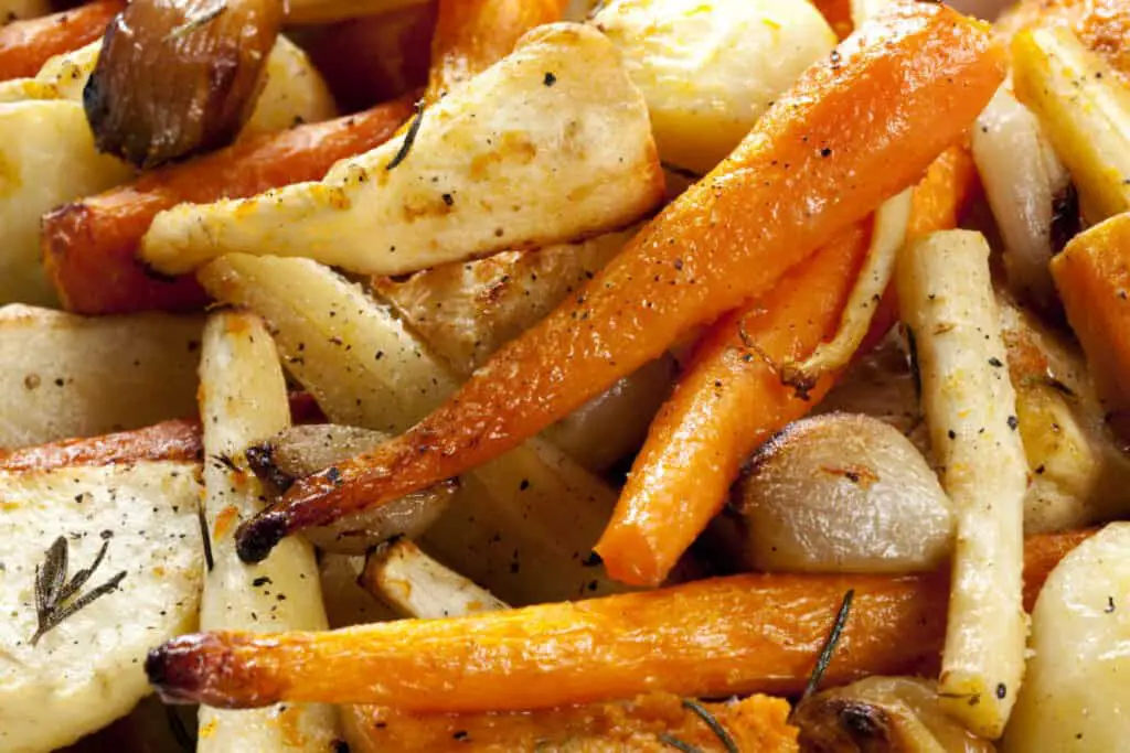 Roasted carrots, parsnips, potatoes, butternut squash, shallots, and garlic bulbs