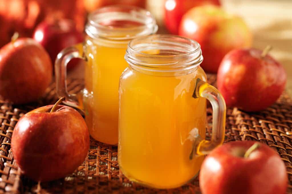 Mason jars filled with hot apple cider.