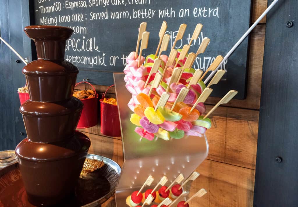 Chocolate fountain and candies for dipping on skewers