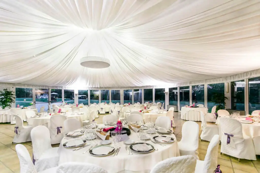 White tables and chairs at wedding reception