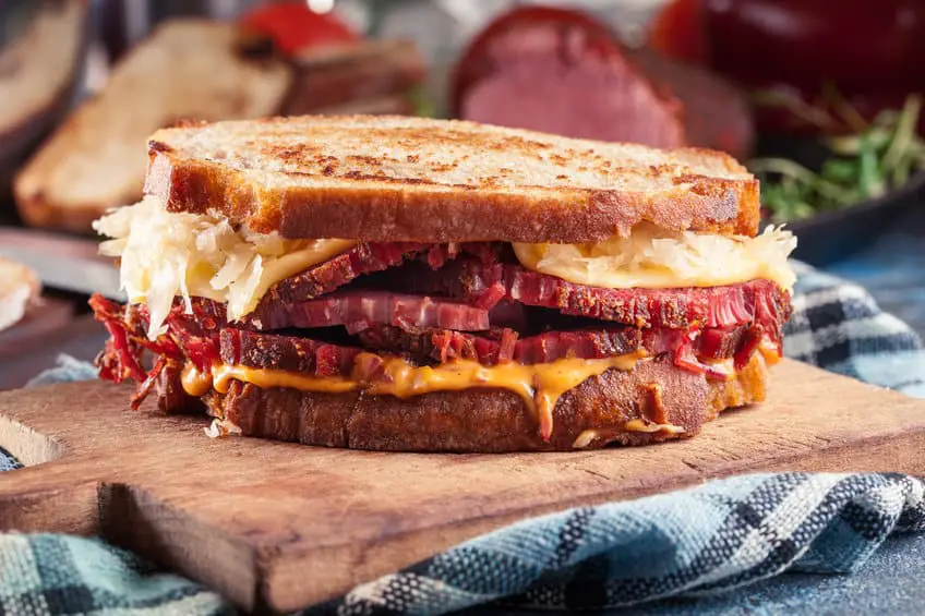 Reuben sandwich with corned beef, cheese and sauerkraut. Classic New York dish