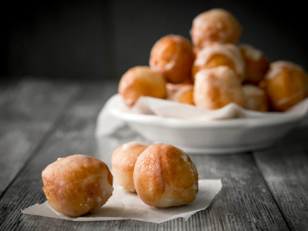 Glazed donut holes on a wooden background