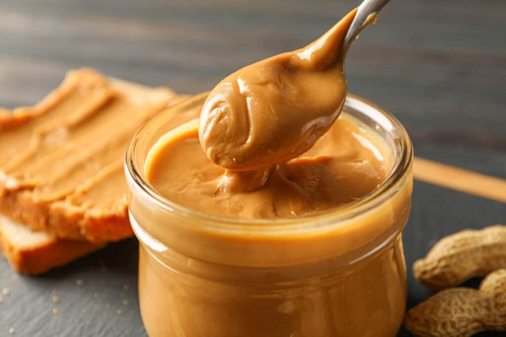 Glass jar with peanut butter and spoon