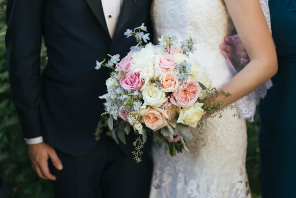 Photo of bride and groom with bouquet
