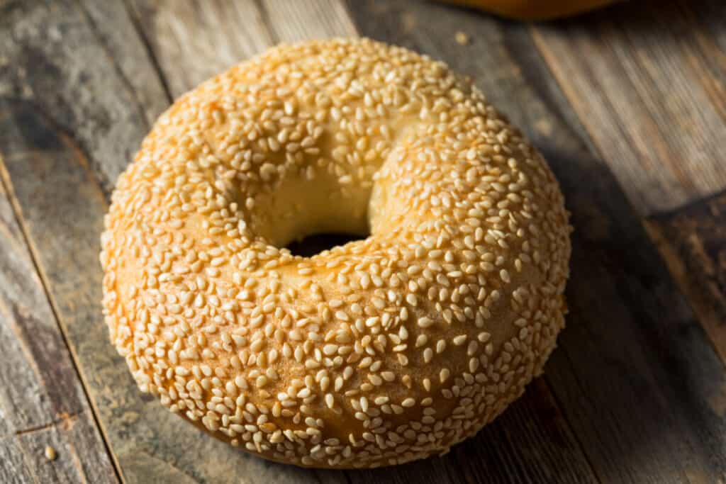 Sesame seed bagel on wooden table