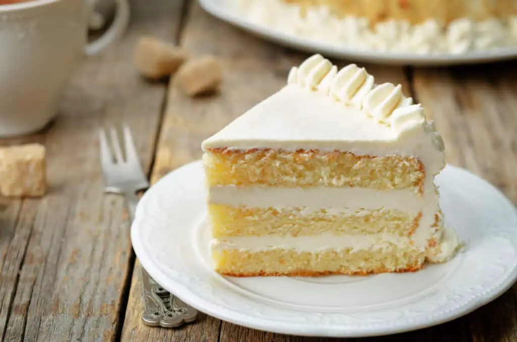Sponge cake with butter cream frosting on white plate