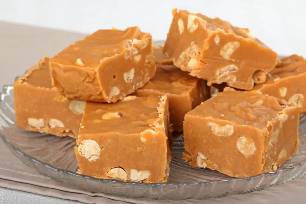 Stack of peanut butter fudge on a glass plate