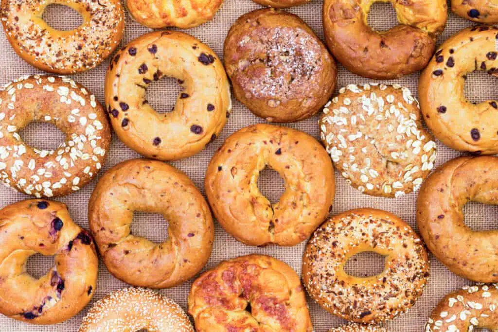 Top view of freshly baked bagels with assorted flavors