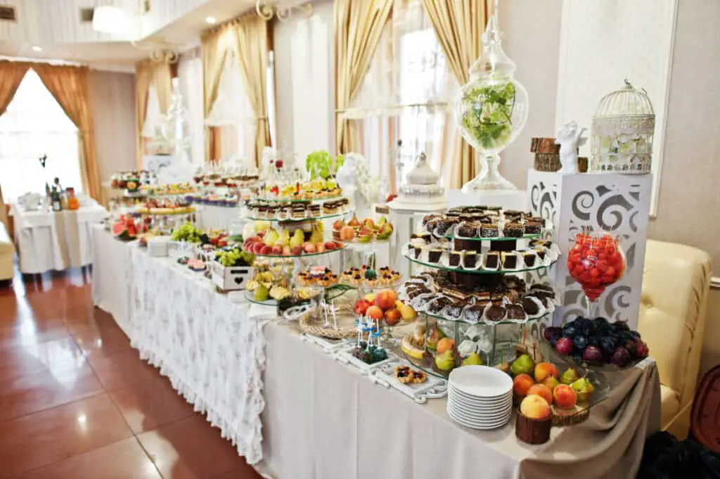 Gorgeous-looking wedding table with various desserts, fruits, and decorations