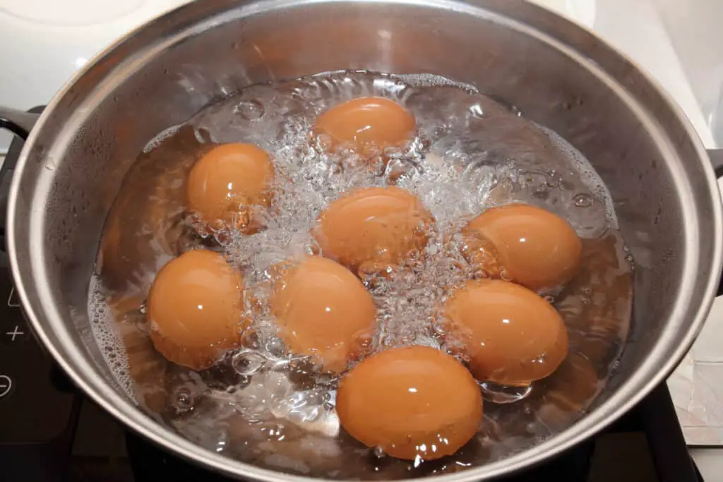 Boiling eggs in a hot pan with boiling water