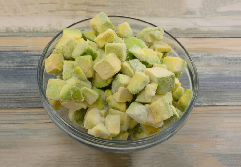 Chunks of frozen avocado in a glass bowl