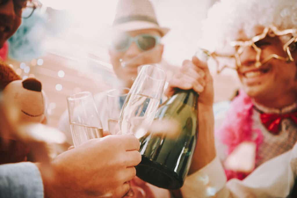 People dressed up at a party drinking champagne