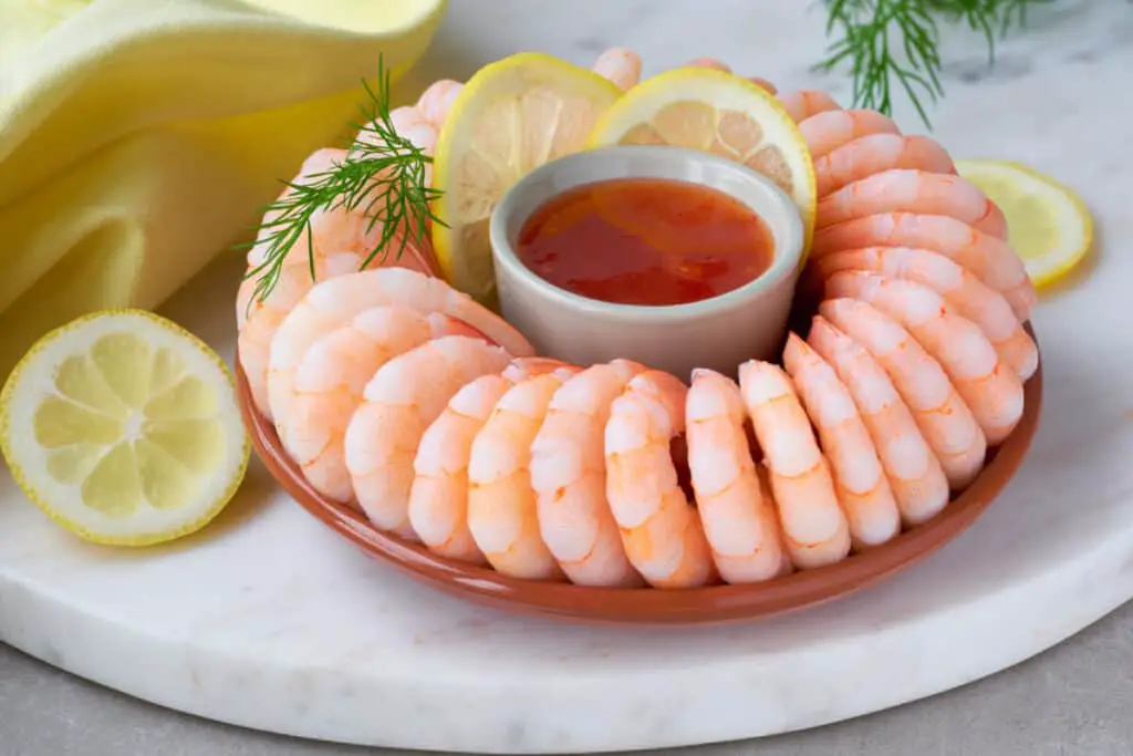Shrimp cocktail platter with cocktail sauce and lemon