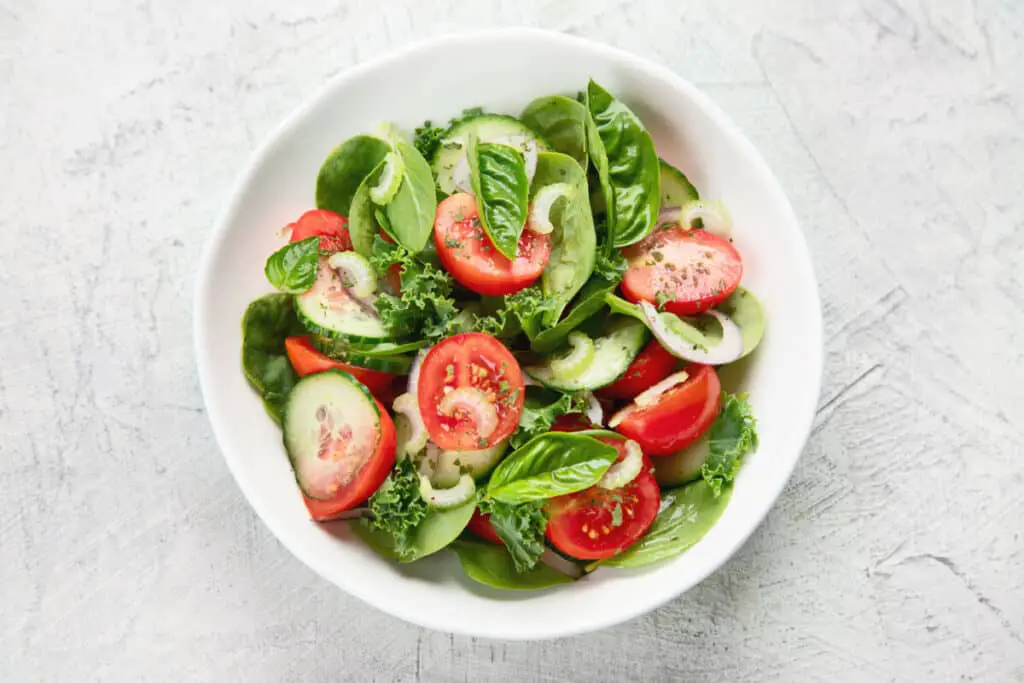 Spinach and kale salad with tomatoes and cucumber