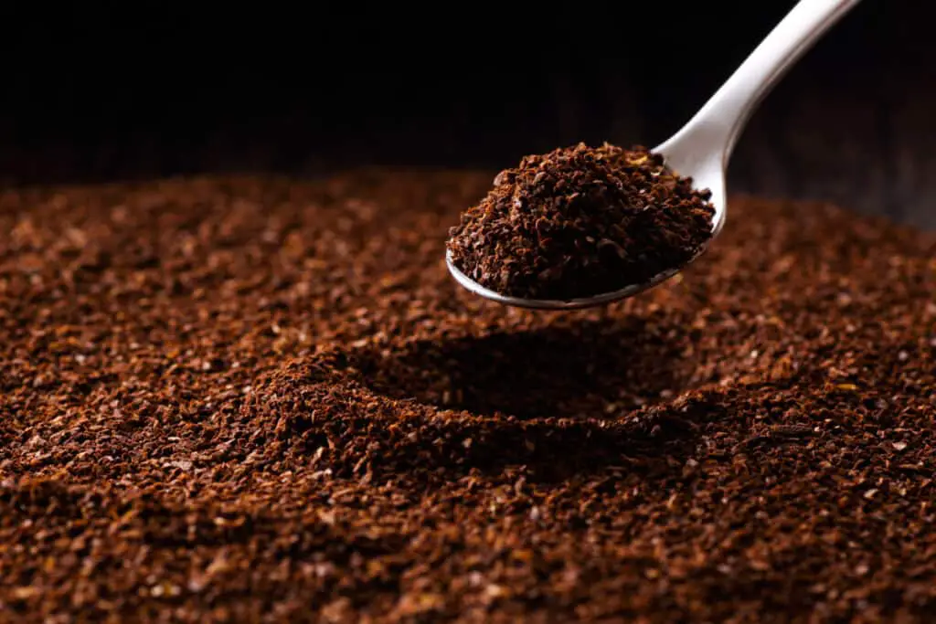 Spoon full of coffee grounds