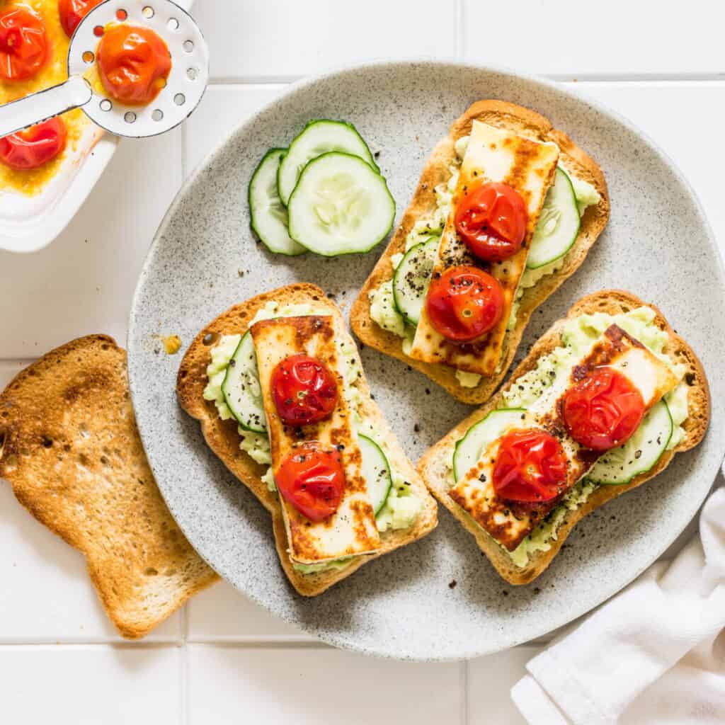 Toast with hummus, cucumbers, and tomato