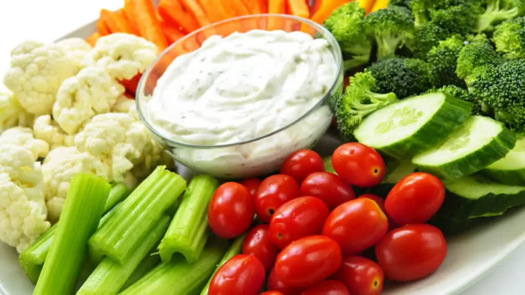Tomatoes, celery, cucumber, carrots, and vegetable dip