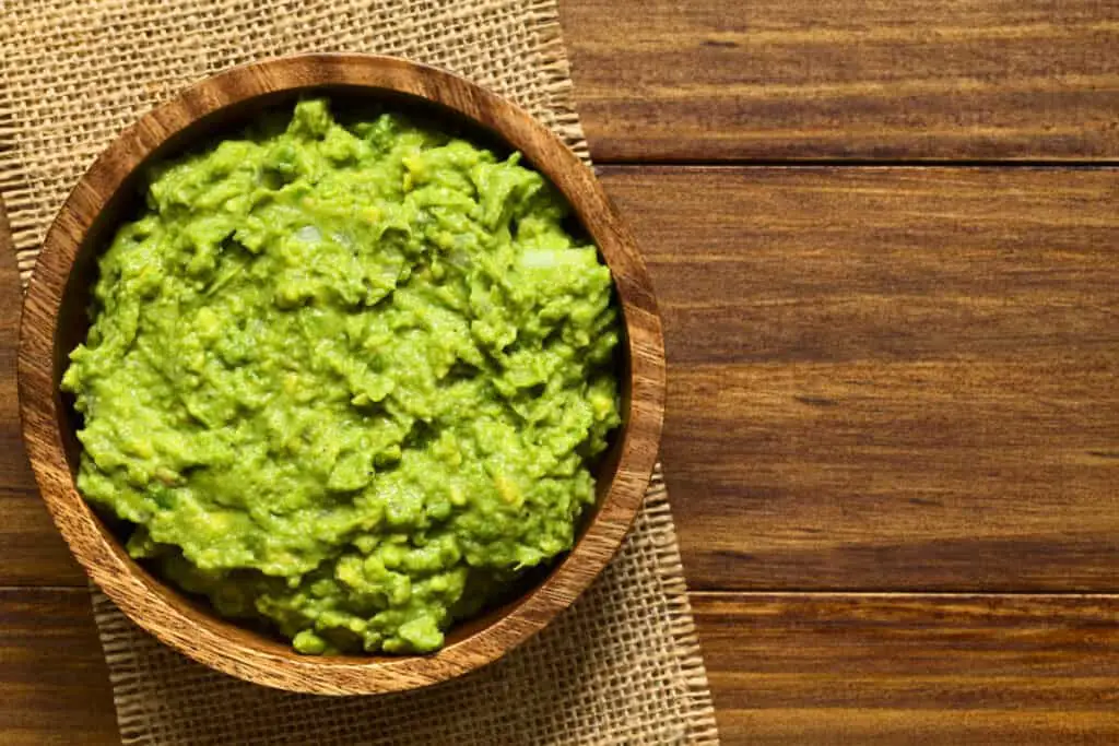 Wooden bowl full of guacamole