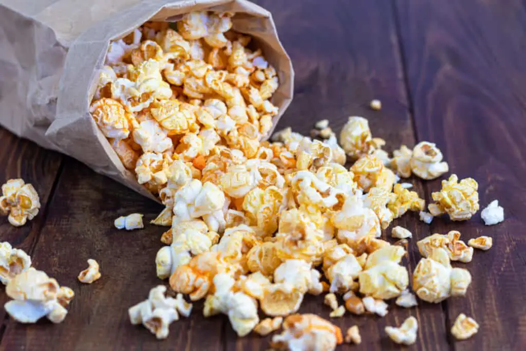 Popcorn spilling out of a brown paper bag