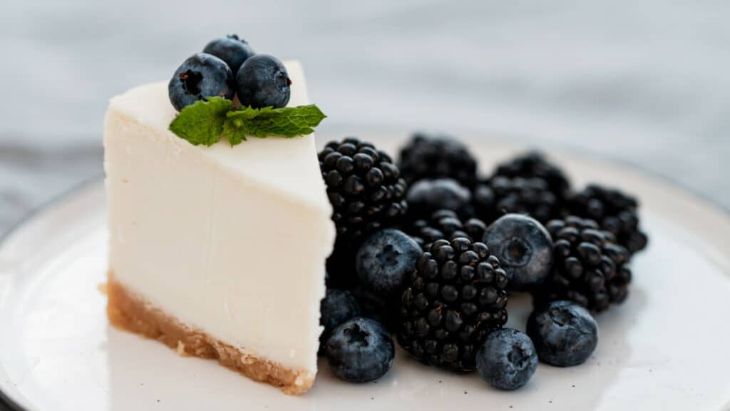 Blueberry cheesecake with fresh berries and mint