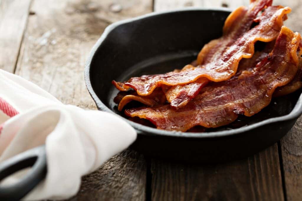 Pieces of bacon in a skillet