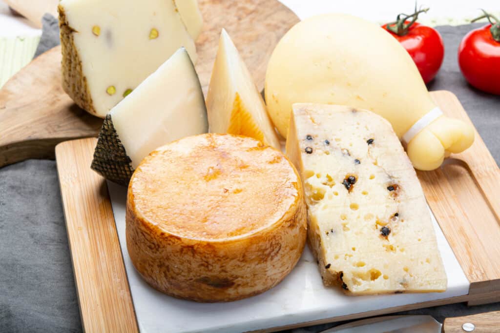 Variety of cheeses on a wooden cutting board