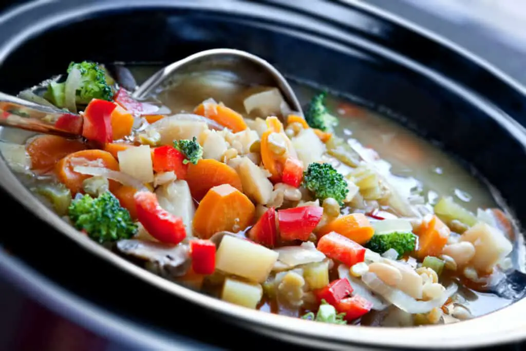 Vegetable soup slow-cooked in a crock pot