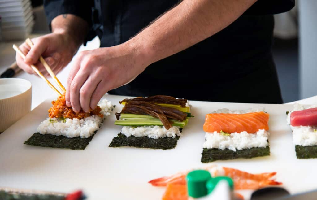 Chef making assorted colorful sushi
