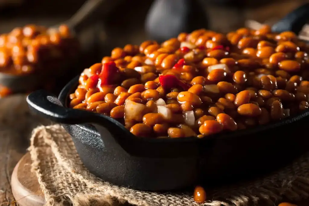 Homemade barbecue baked beans in a black skillet