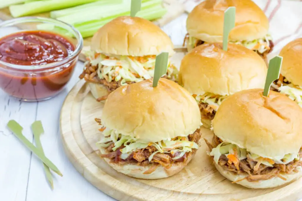 Pulled pork sandwiches with coleslaw, BBQ sauce, and celery