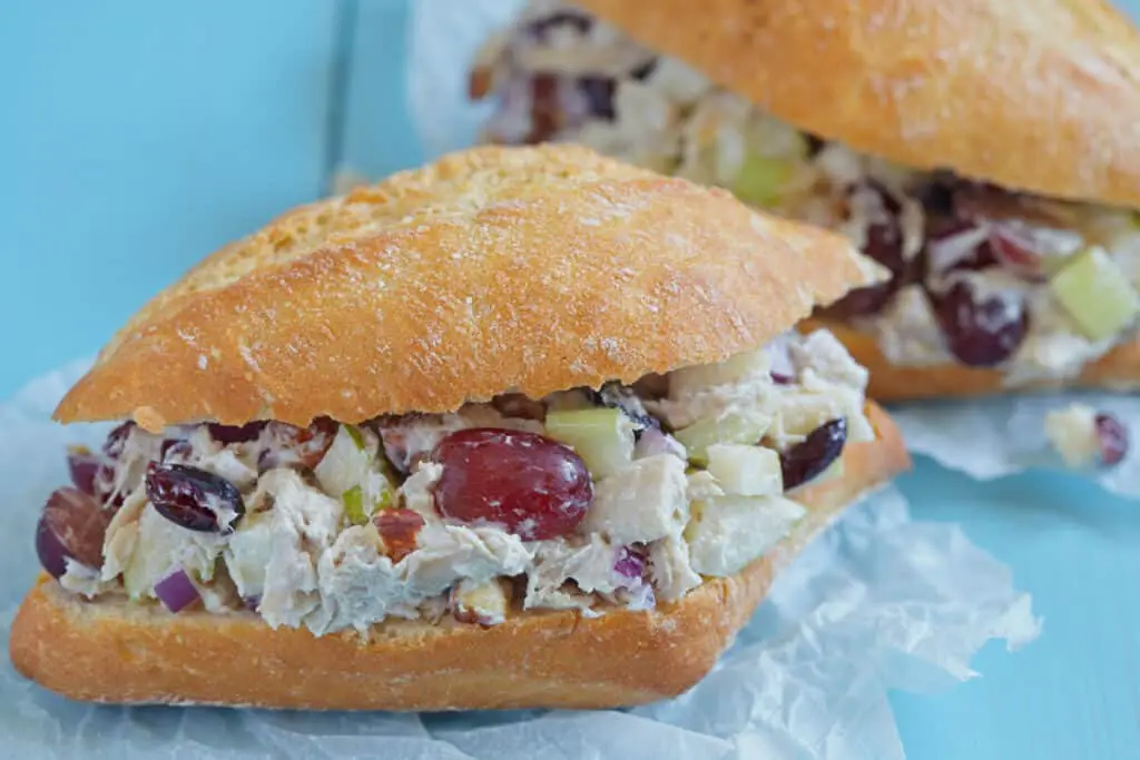 Chicken salad sandwich with apple, grape, celery, almond, dried cranberry, and greek yogurt.