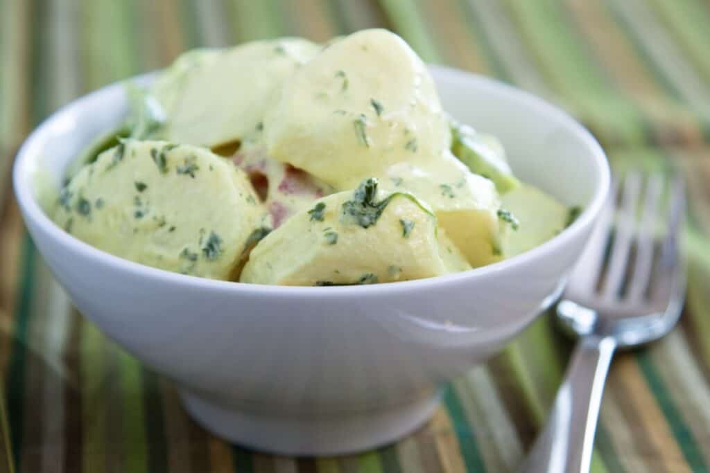 Delicious creamy german potato salad dressed in mayo infused with mustard and parsley