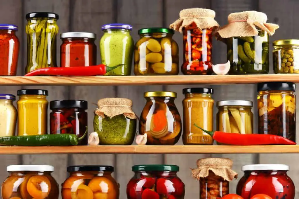 Jars of sauce, olives, pickles, and vegetables.