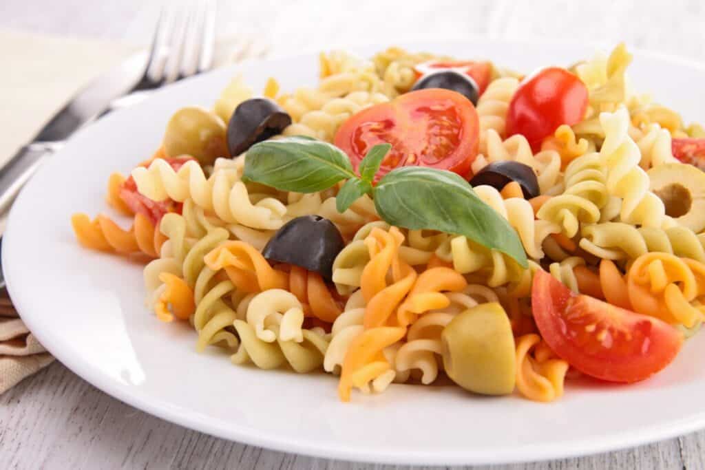 Pasta salad with olives, tomatoes, and basil