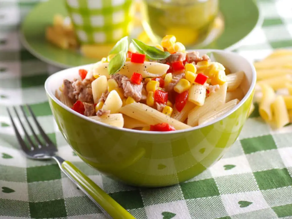 Pasta salad with tuna, red pepper, corn, and basil.