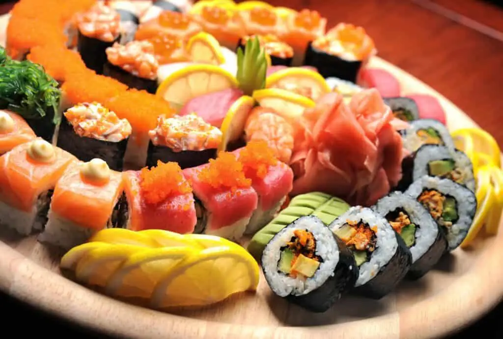 Variety of colorful sushi with ginger and wasabi.