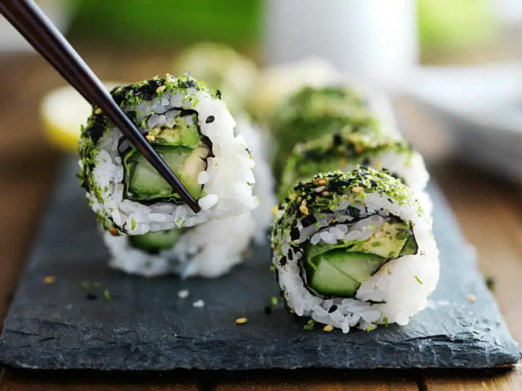 Vegetarian sushi with cucumber, avocado, and sesame seeds.