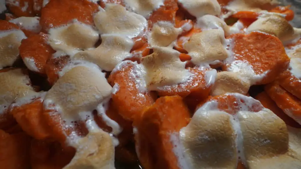 Baked sweet potatoes with browned marshmallows on top.