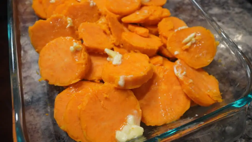 Close-up of baked sweet potatoes with butter on top.