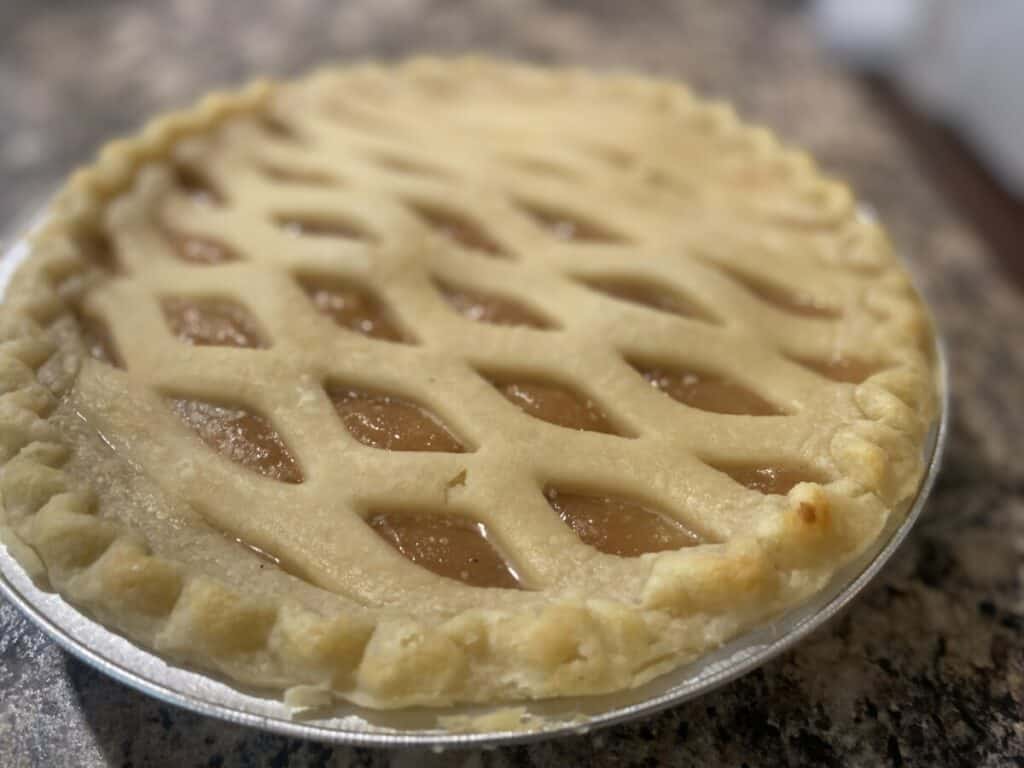 Close-up of an apple pie in a tin dish.