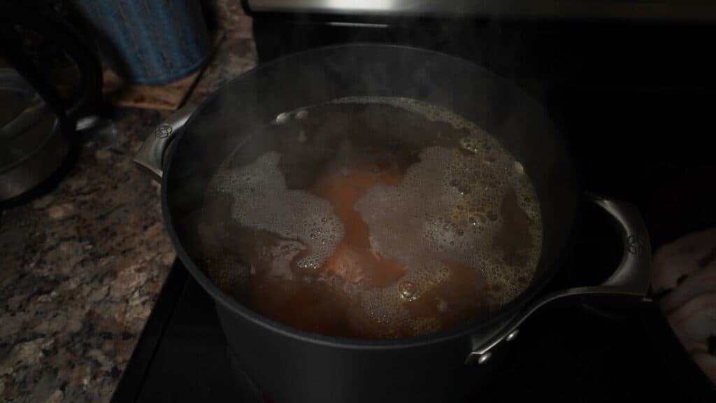 Sweet potatoes boiling in a large pot.